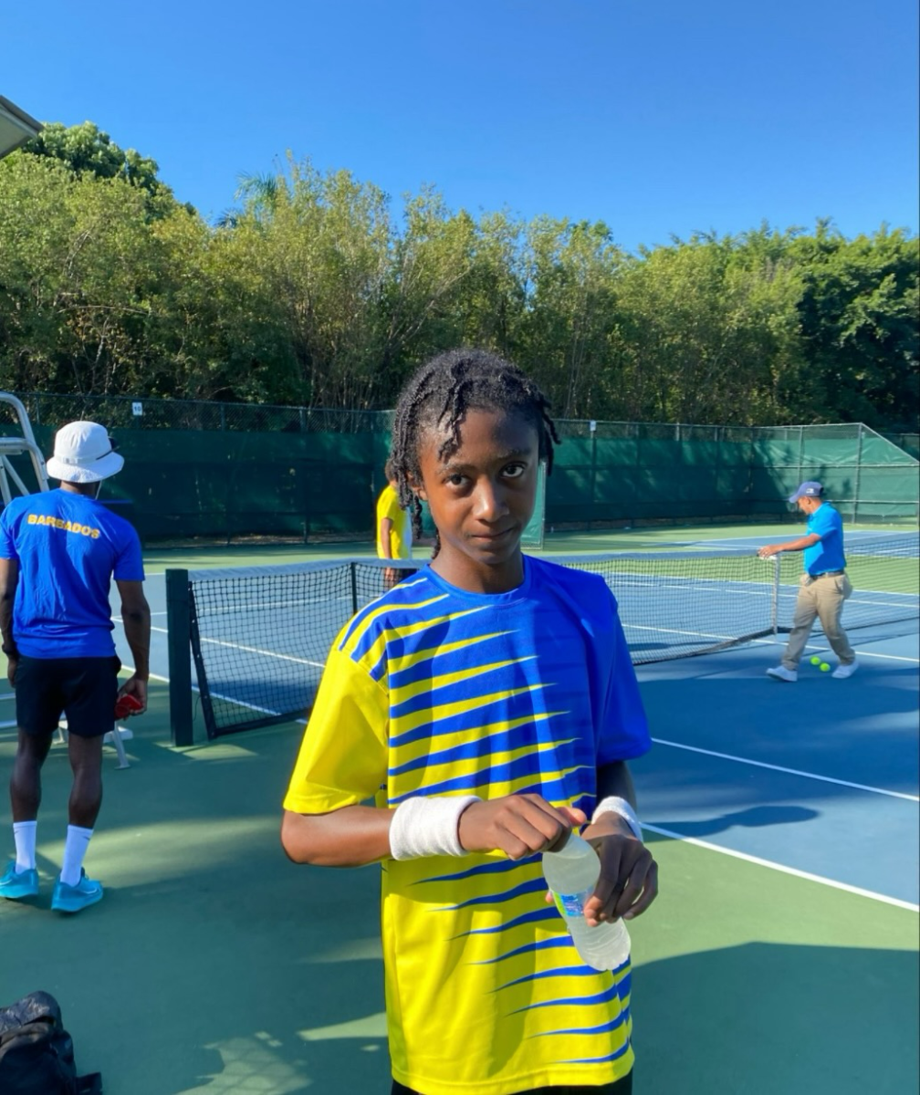 Sophomore Lucas D. is pictured taking a water break before representing Barbados at the Junior Davis Cup against the U.S. Virgin Islands. 