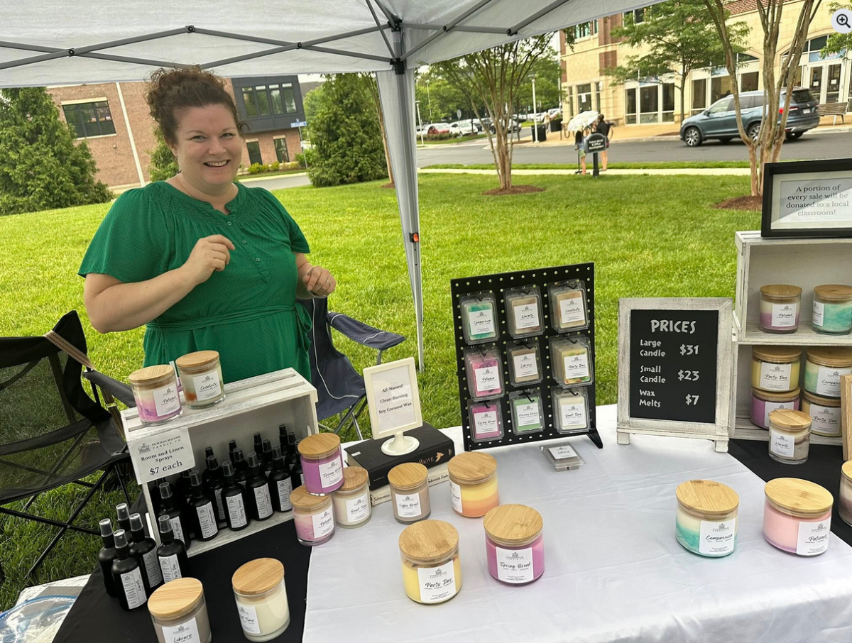 Whitney Keaton sets up a stall for her business, Schoolhouse Candle Company, at a local event.